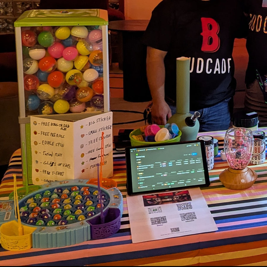 Budcade prize table with a gacha machine full of capsules and a fishing prize game