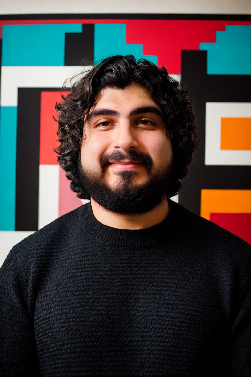 Joe Leybovich in front of colorful pixel art
