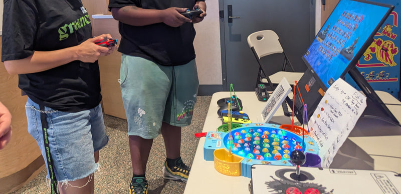 Guests playing beside the fishing prize game at GreenCup