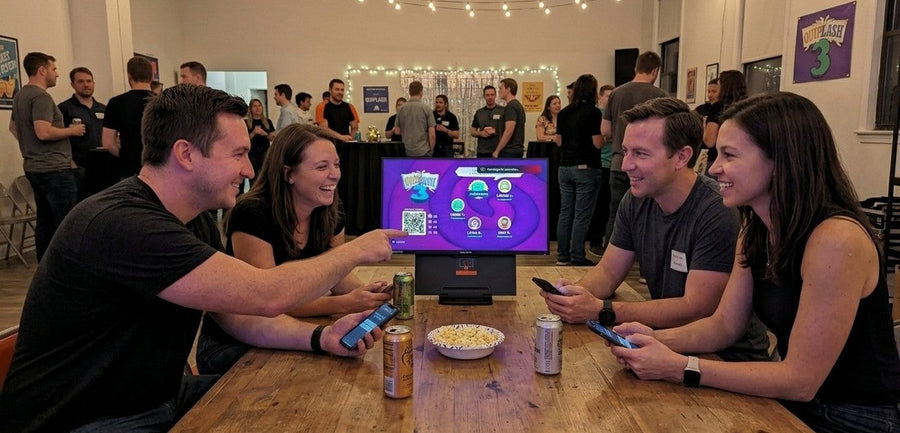 Example mobile party game setup: friends playing on their phones around one screen