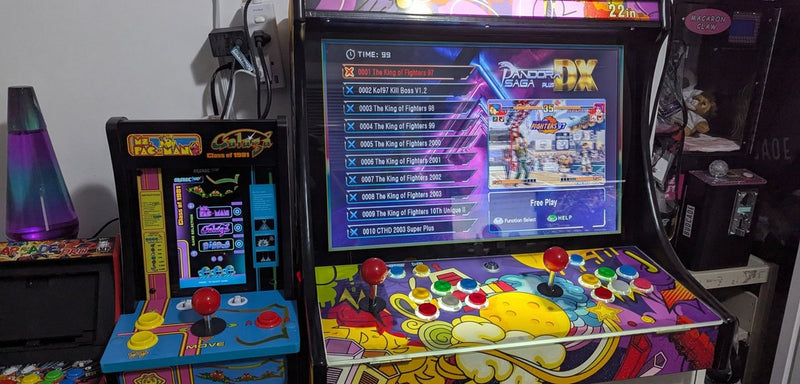 Retro arcade cabinets with joysticks and a game list on screen