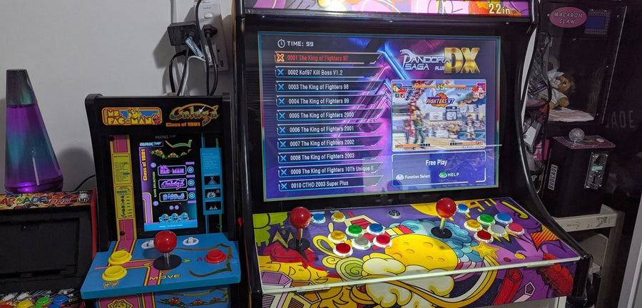 Retro arcade cabinets with joysticks and a game list on screen