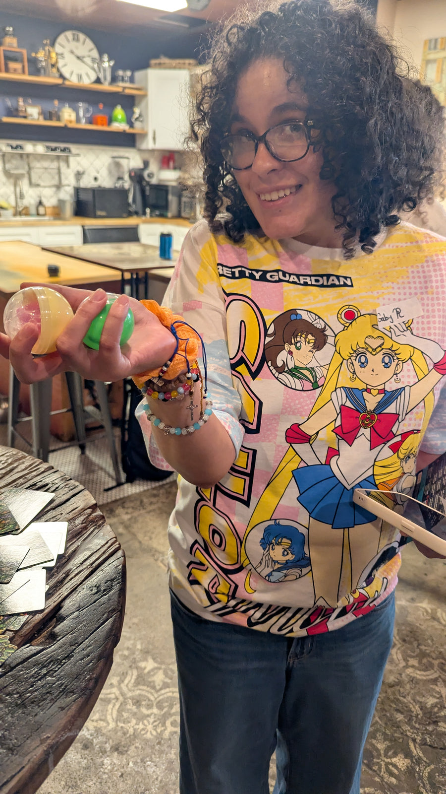 Guest holding a prize capsule she won from the Budcade gacha machine