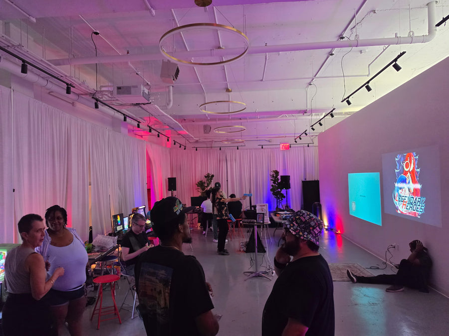 Wide room with guests and game screens, Budcade at Trends LIC